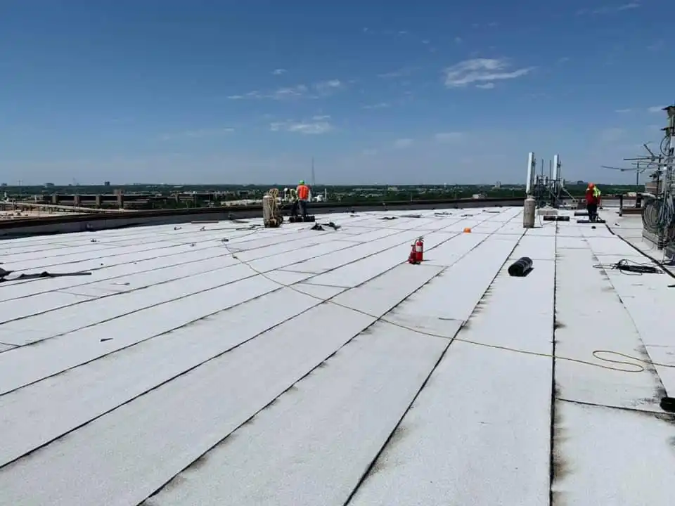 Roofing crew installing modified bitumen overlay Dallas Texas