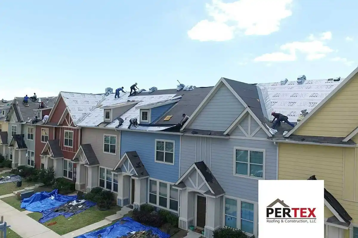 Roofing crew replacing roofs on townhome community