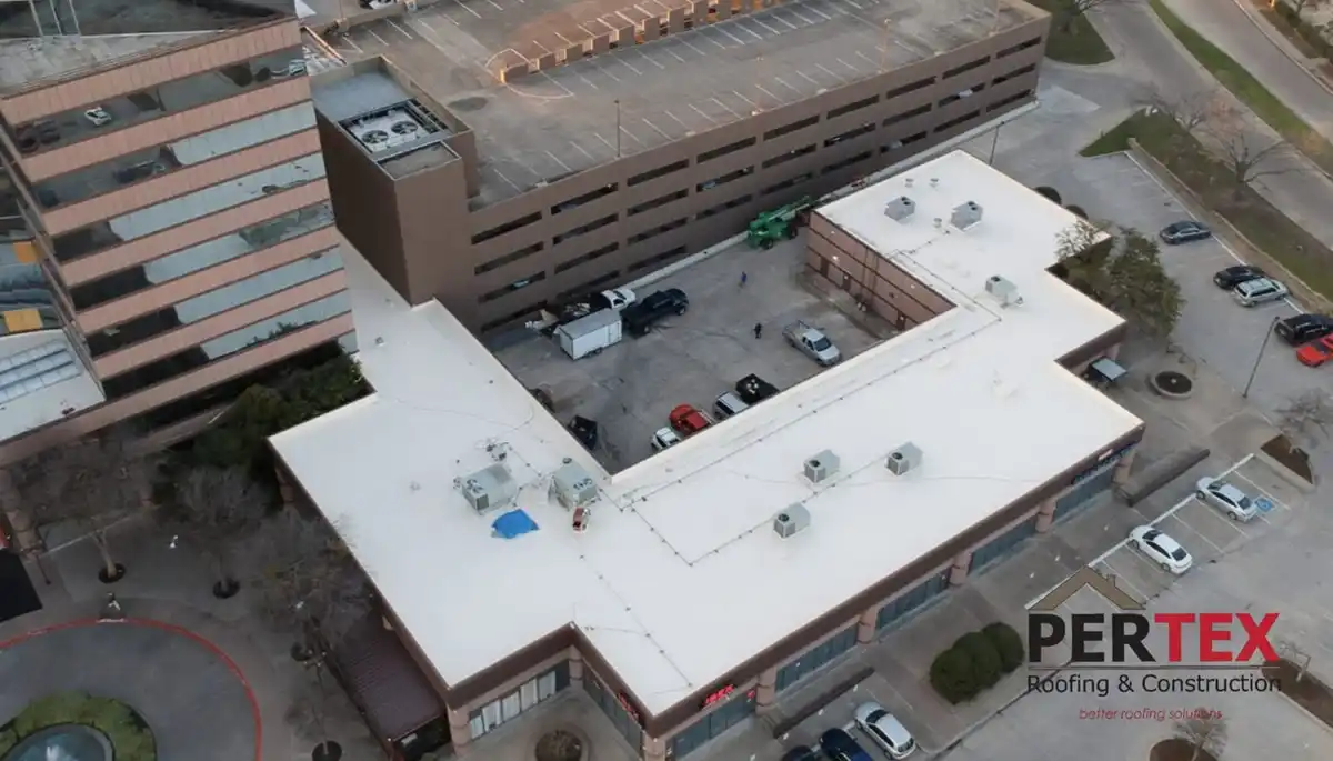 Aerial view of completed white commercial roof