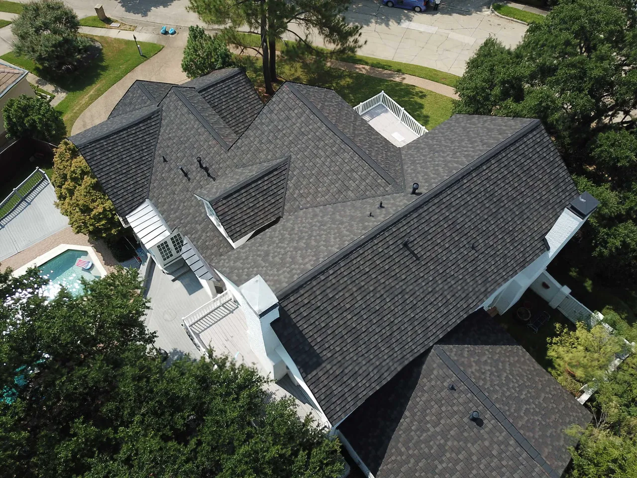Drone aerial view of completed Boral black metal shingle roof, Class 4 impact rated, on a Las Colinas Texas home