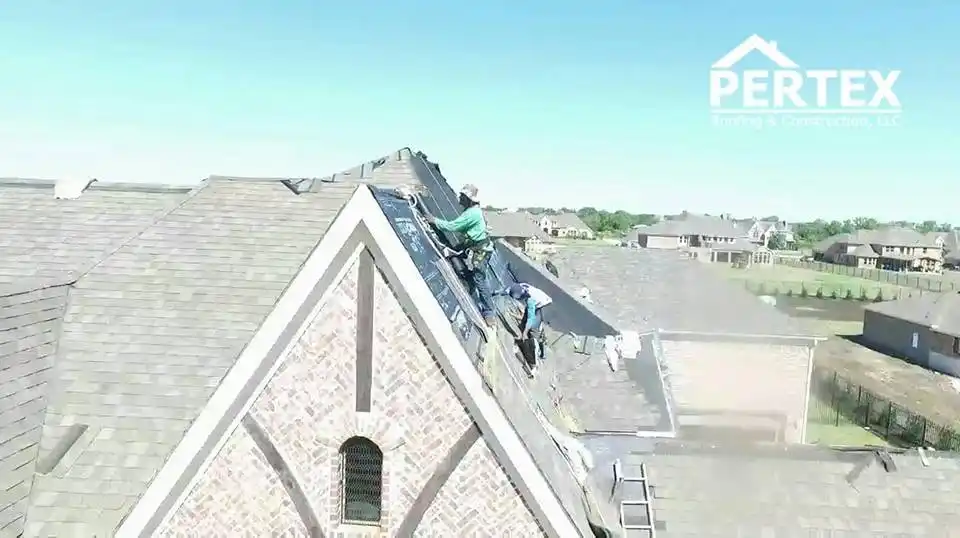 Crew installing shingles on steep 16/12 pitch roof